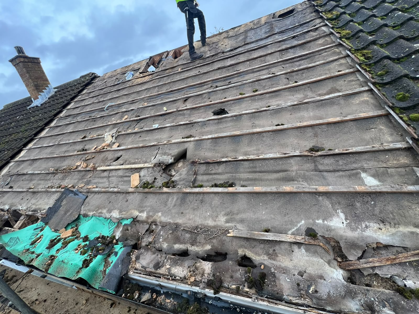 Before — old damaged roof